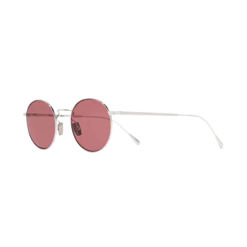 Seitenansicht der AUSN 0001 – schlanke Bügel in Weißgold-Rhodium-Finish mit rosaroten Gläsern, leicht und elegant.