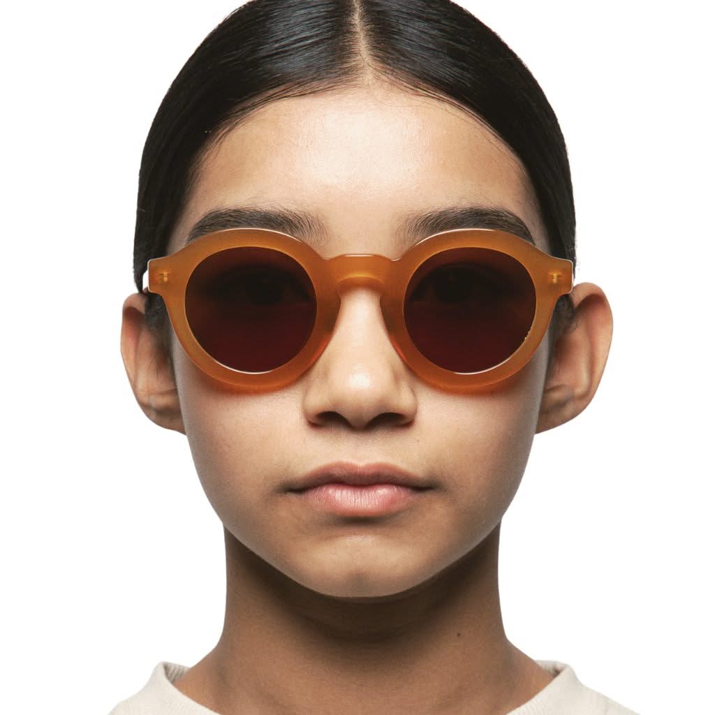 Kind trägt die Kaleos Kids WAIALIKI col. 3 Sonnenbrille in Braun – erhältlich bei Brillen Schneider in München.